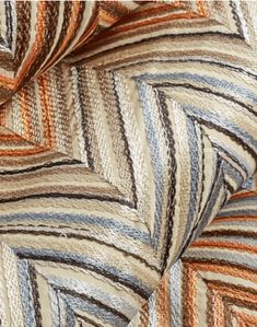 an up close shot of a multicolored fabric with wavy lines on the side