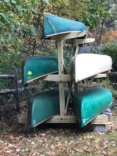 several canoes are stacked on top of each other