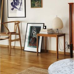 a living room filled with furniture and pictures on the wall next to a wooden table