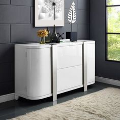 a white sideboard in a room with grey walls