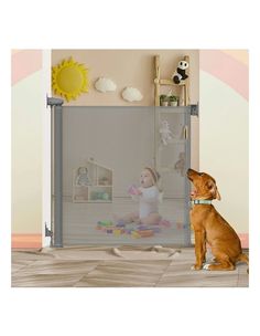 a dog sitting in front of a baby gate