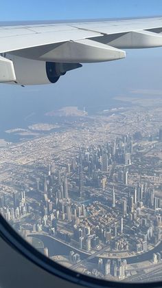 the view from an airplane window looking down on a city