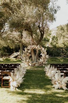 an outdoor ceremony setup with chairs and flowers