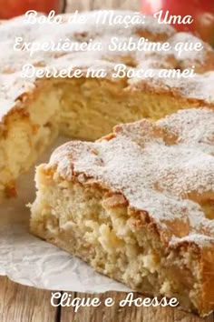 a piece of cake with powdered sugar on top and an apple in the background