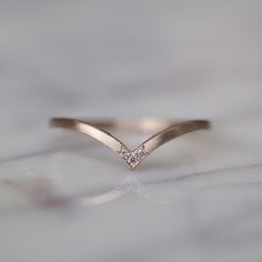 a diamond ring sitting on top of a table