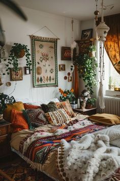 a bed room with a neatly made bed and lots of plants on the windowsill