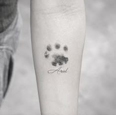 a person with a small tattoo on their leg that has a dog's paw print