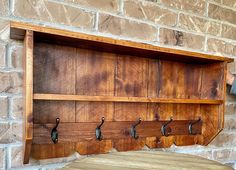 the coat rack is made out of wood and has five hooks on each hooks