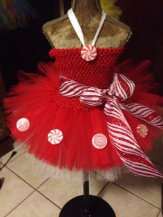 a red and white dress with candy canes on it