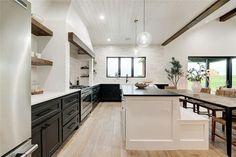 a large kitchen with black and white appliances