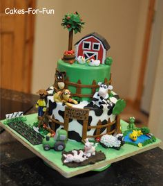 a birthday cake decorated with farm animals and farmer's life on the top tier