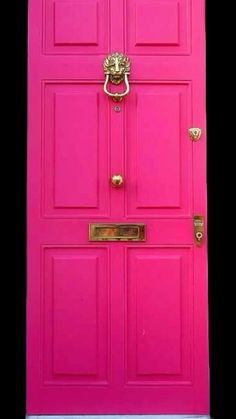 a bright pink door on a white house