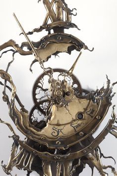 the clock is made out of metal and has gears attached to it's sides