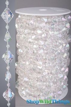 a white vase with crystal beads hanging from it's side and another photo of the vase