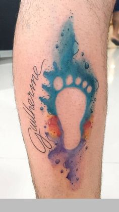 a man's leg with a watercolor tattoo on it