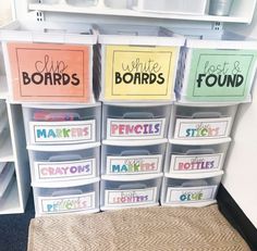 several bins with different labels on them in front of a shelf filled with plastic containers