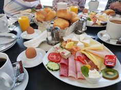 a table filled with breakfast foods and drinks