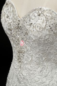 the back of a wedding dress with beading on it