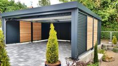 an outdoor garage with wooden doors and brick flooring, surrounded by greenery on both sides