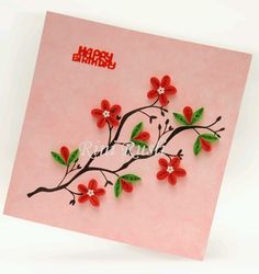 a pink card with red flowers on it