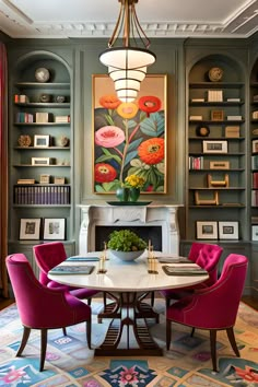 a dining room with colorful chairs and a painting on the wall in the centerpiece