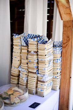 stacks of food sitting on top of a table next to a white table cloth covered tray