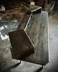 a wooden table with an open shelf on it