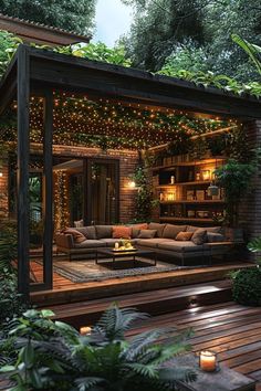 an outdoor living area is lit up with string lights