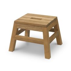 a small wooden stool sitting on top of a white floor