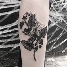 a black and white photo of a rose tattoo