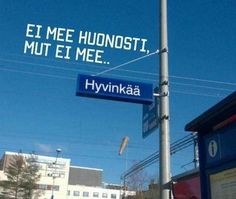 a blue street sign hanging from the side of a metal pole