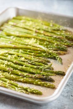 the asparagus are ready to be cooked in the oven on the baking sheet