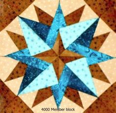 a blue and brown star quilted on top of a wooden table