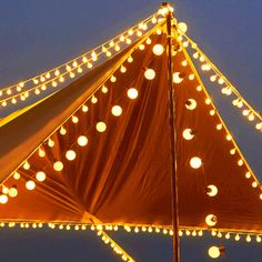 the top of a tent with lights all around it