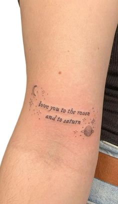 a person with a tattoo on their arm that reads, you're to the moon and i'm to saturn