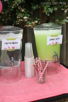 two plastic cups with straws and drinks on a table