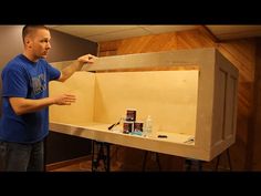 a man standing in front of a wooden box