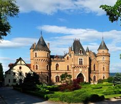 an old castle with many towers and windows on the top of it's roof