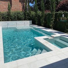 an empty swimming pool in the middle of a garden