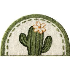 a green and white cactus rug with an orange flower on the center, sitting in front of a white background