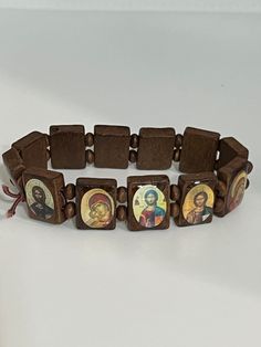 Hand-made prayer bracelet. Pray to your favorite saint and keep them close at all times. It consists of small icons  mounted on wooden slabs, which are separated by wooden beads and strung onto an elastic sized wristband.  Made of elastic cord, to apply on every wrist it is made of high quality wooden the icons are printed and laminated. Stretches. I wear mine everyday so I can have my prayers close to me.  This is an Orthodox prayer bracelet, say the Jesus prayer as you scroll by each icon.  Th Saints Bracelet Wooden, Traditional Wooden Bracelets As A Gift, Traditional Wooden Bracelet As Gift, The Jesus Prayer, Souvenir Ideas, Icon Images, Orthodox Prayers, Christian Bracelets, Small Icons