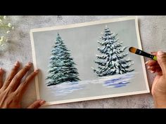 someone is painting trees in the snow with watercolors on paper and crayons