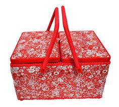 a red and white bag with flowers on it's sides, sitting in front of a white background