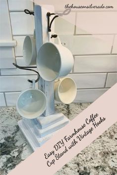 four coffee cups on a stand with the words easy diy farmhouse coffee cup stand with vintage hooks