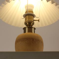 a lamp that is sitting on top of a table next to a white light bulb