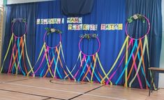 an indoor basketball court decorated with ribbons and hoop tossers for a birthday party or celebration