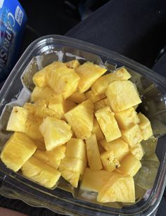 a plastic container filled with cut up pineapple