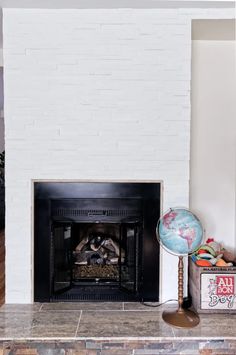 a fireplace with a globe on the mantle