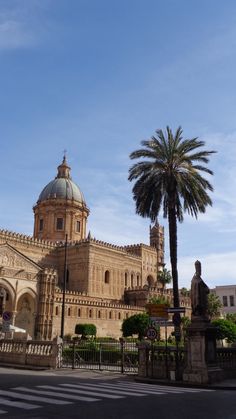 an old building with a palm tree in front of it