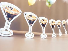 several martini glasses lined up on a table